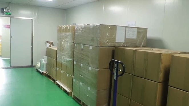 Sealed medical product carton next to shipping documents and barcode labels