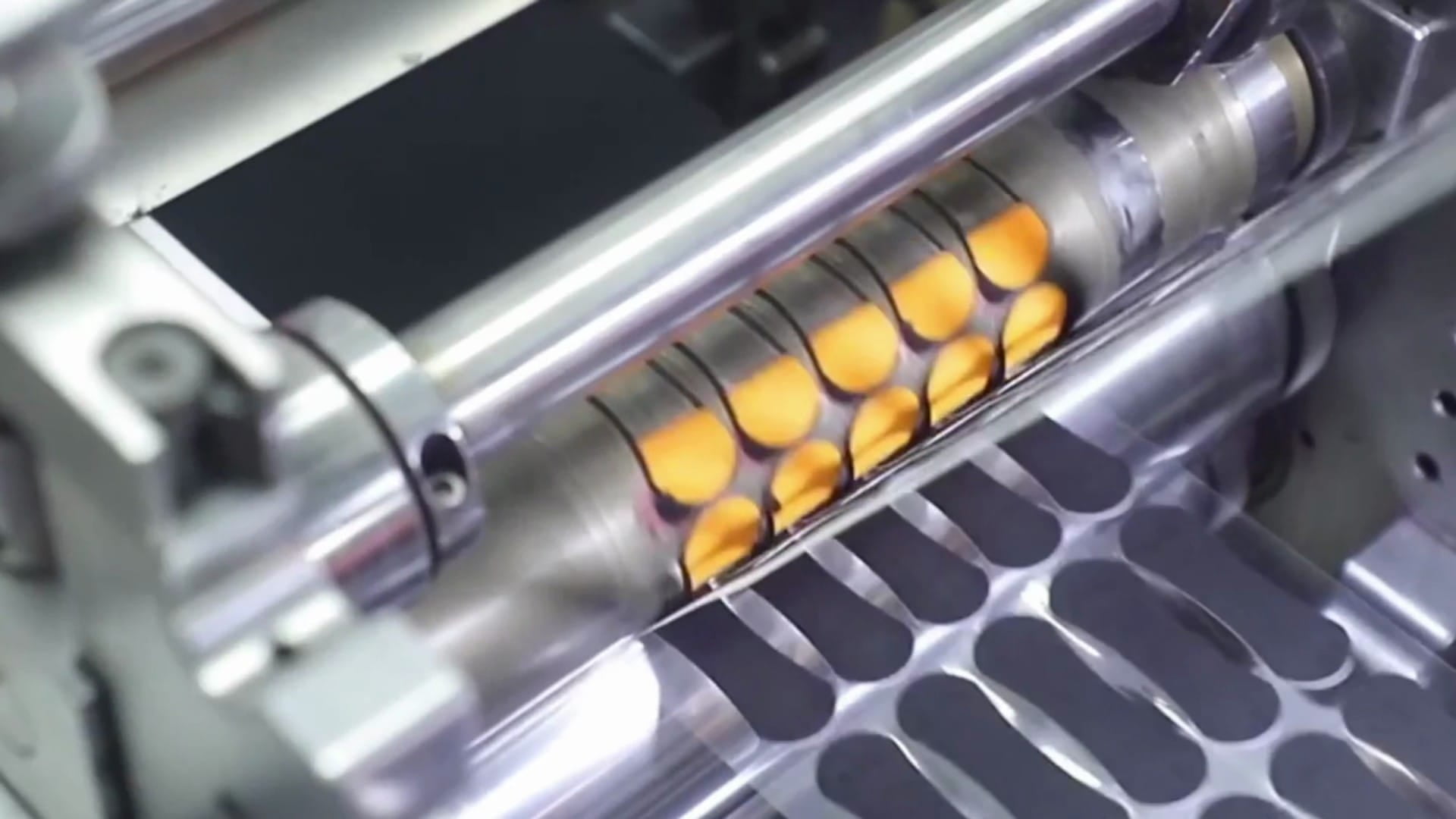 Neatly stacked medical adhesive strips in small production quantities on a white lab table